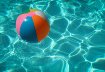 Image: A colorful beach ball floats in a swimming pool