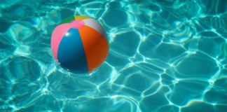 Image: A colorful beach ball floats in a swimming pool