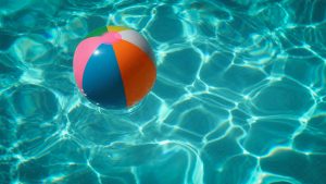 Image: A colorful beach ball floating in pool water