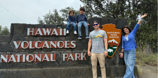 Image: A family at the entrance to Hawaii-Volcanoes National Park