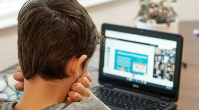 ADHD: What You Need to Know Before and After a Diagnosis Image: A young boy uses a device for schoolwork