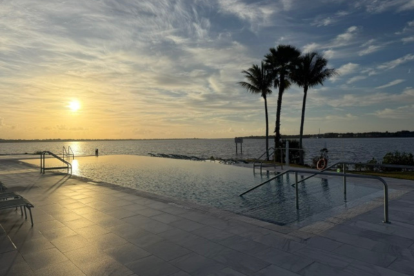 Image: A sunset view of the infinity pool at voco Sandpiper Bay