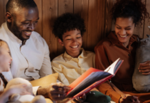 Black History Month Picture Books to Read With Kids Image: A father and mother enjoy a picture book with their daughter and son