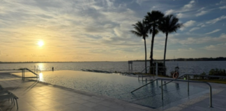 Image: A sunset view of the infinity pool at voco Sandpiper Bay All-Inclusive Resort