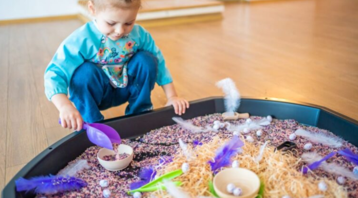 Sensory Play: A Mom’s Guide to Supporting Child Development Image: A little girl plays with a large sensory mat