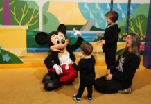 Disney World Spring Break Tips: The Things No One Tells You Image: Mom of two with her boys and Mickey Mouse at Walt Disney World