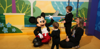 Disney World Spring Break Tips: The Things No One Tells You Image: Mom of two with her boys and Mickey Mouse at Walt Disney World
