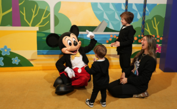 Disney World Spring Break Tips: The Things No One Tells You Image: Mom of two with her boys and Mickey Mouse at Walt Disney World